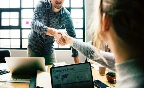 Two professionals shaking hands during a business meeting