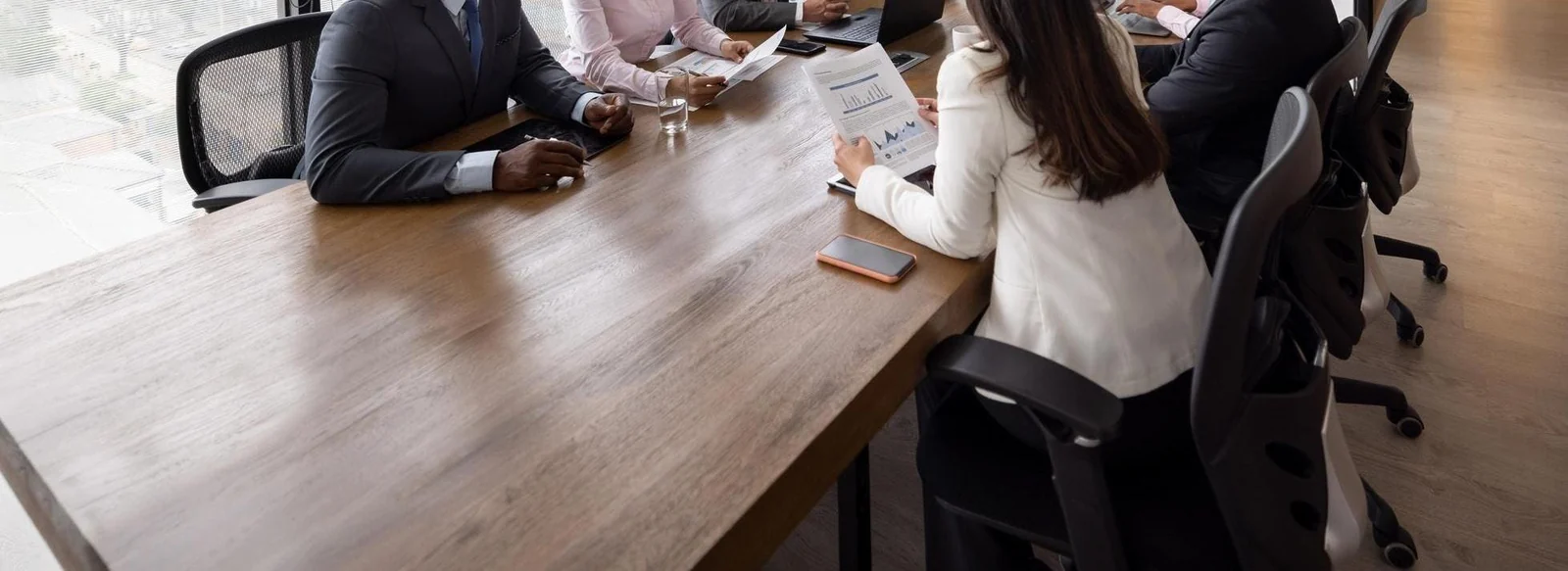 Professionals discussing projects around a meeting table